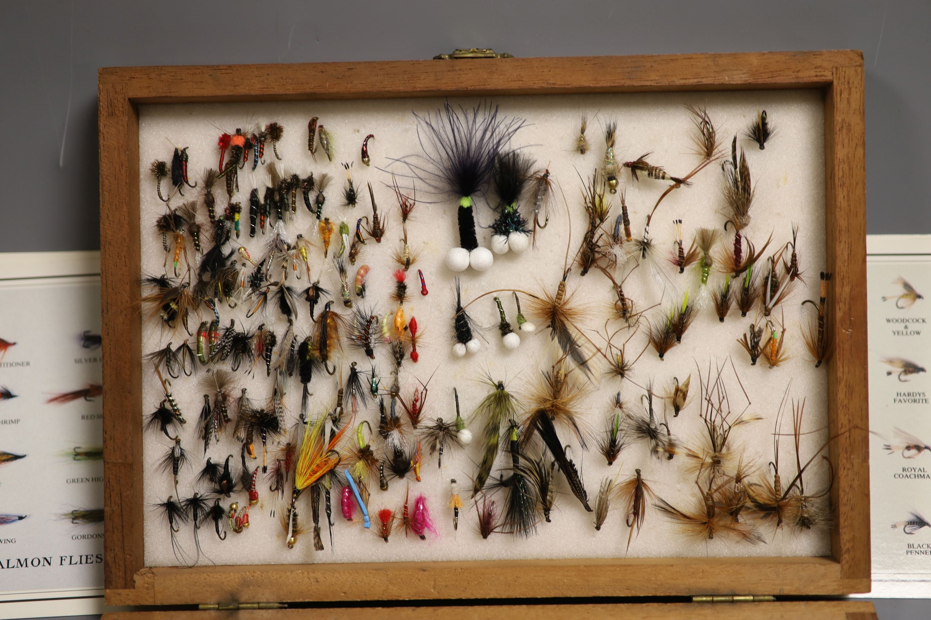 A cased collection of various fishing flies